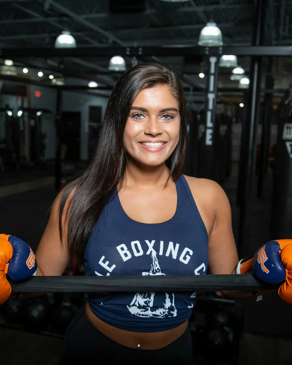 A fitness-studio owner smiling in her gym