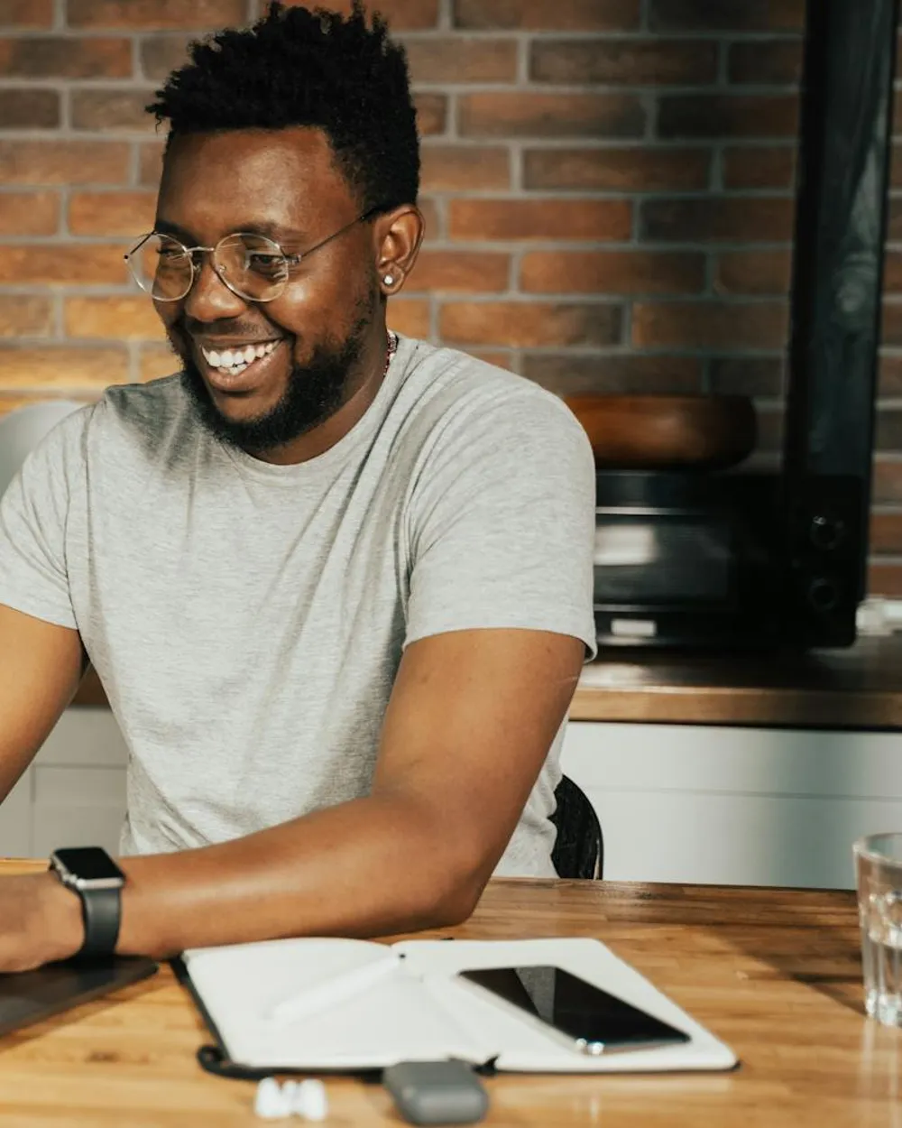 A public-services worker smiling at his desk