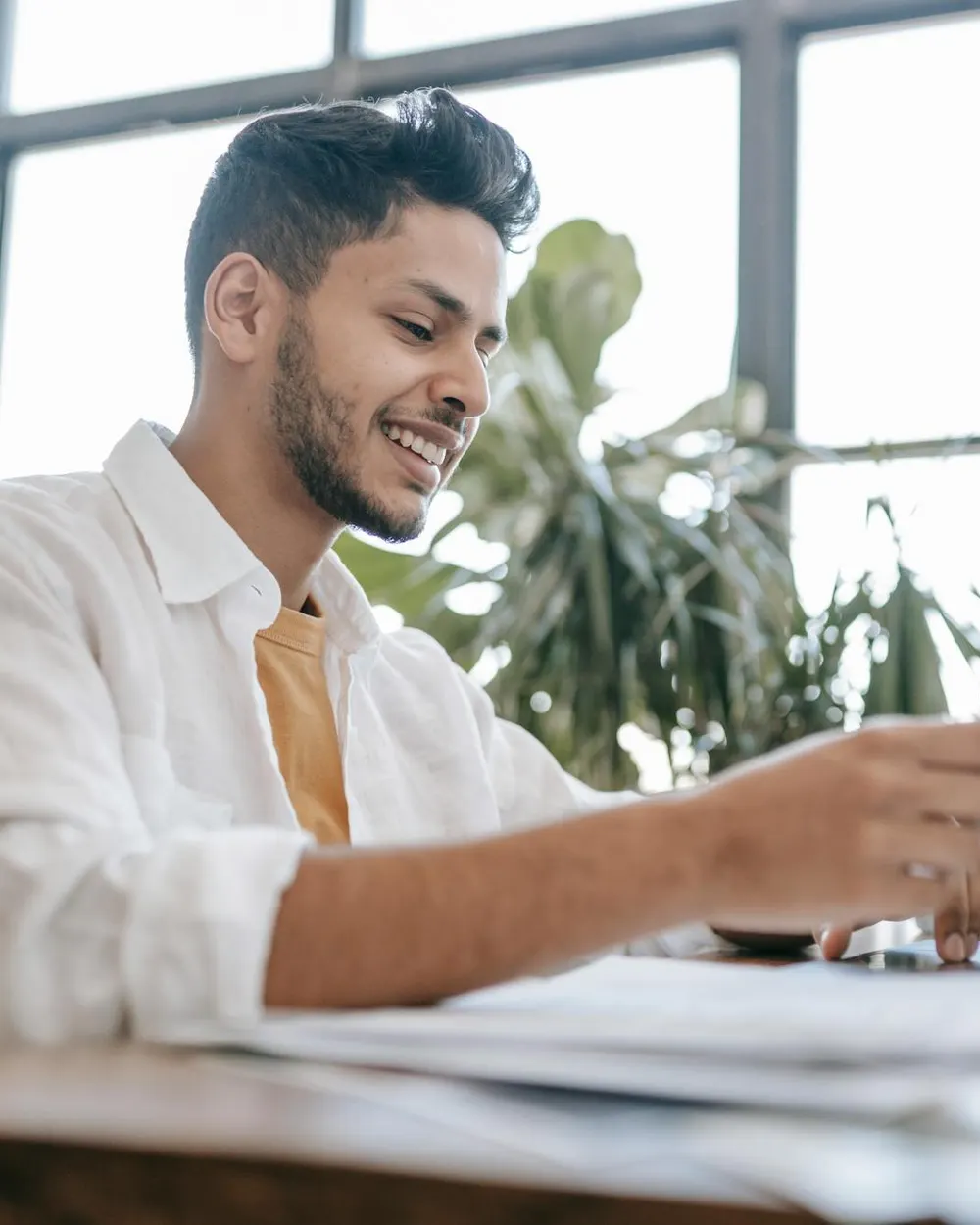 An attorney reviewing documents at a sunny office desk