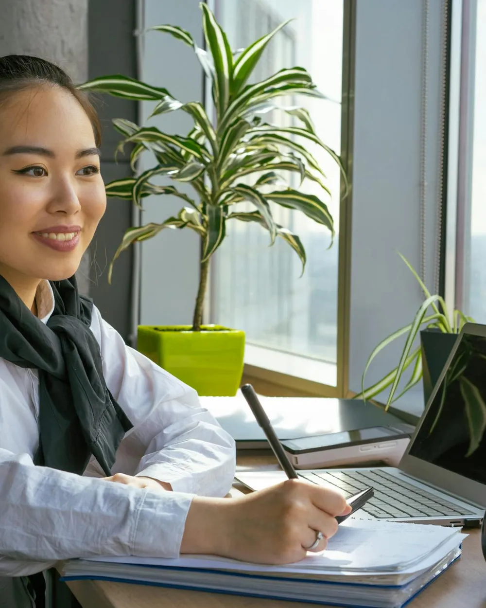 A real-estate agent smiling at her desk